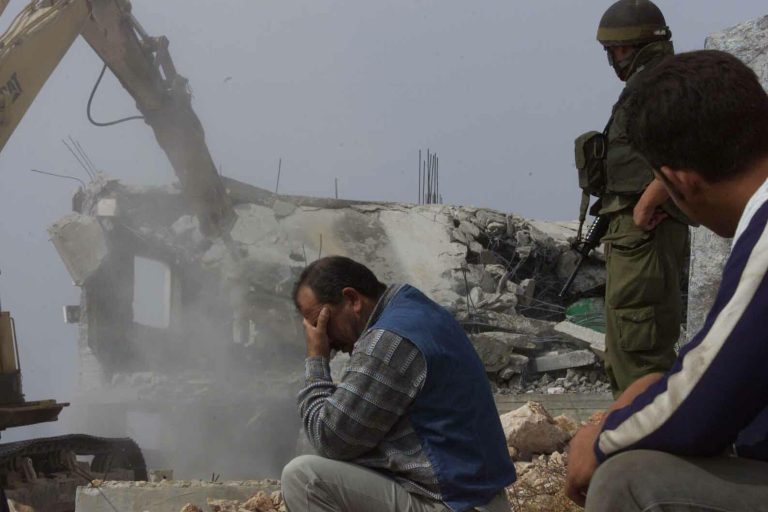 A-Palestinian-man-cant-look-as-his-home-is-demolished